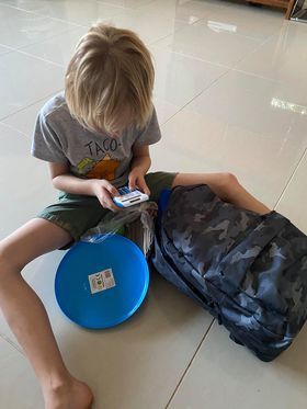 A young boy is sitting on the floor playing a video game.