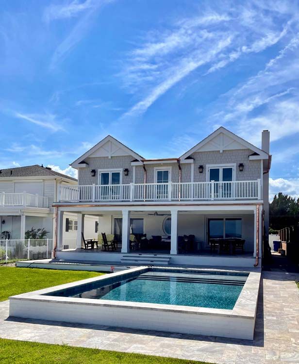 A large house with a large swimming pool in front of it