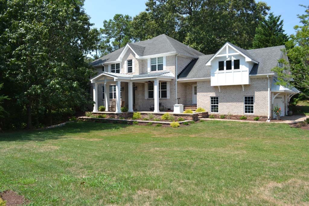 A large house with a large lawn in front of it