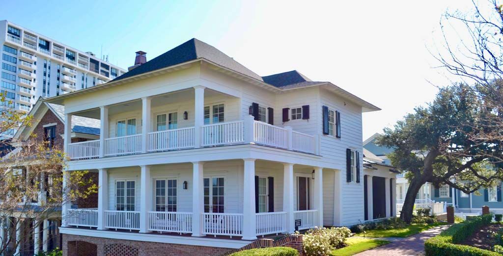 A large white house with a lot of windows and porches