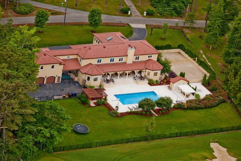 An aerial view of a large house with a swimming pool