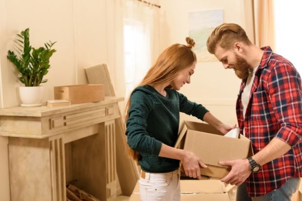 Moving Service — Couple Opening A box in Lorton, VA