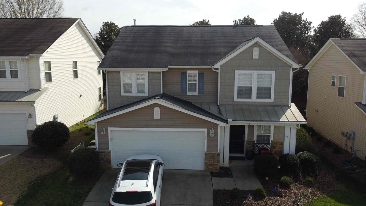 An aerial view of a house with a car parked in front of it.