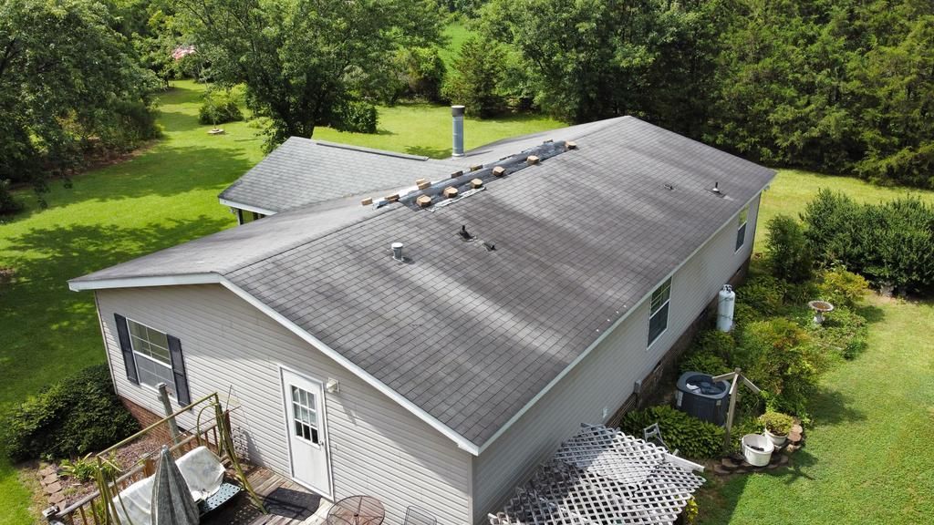 An aerial view of a house with a roof that is covered in shingles.