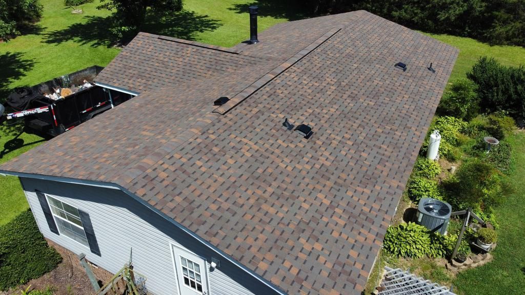 An aerial view of a house with a new roof.