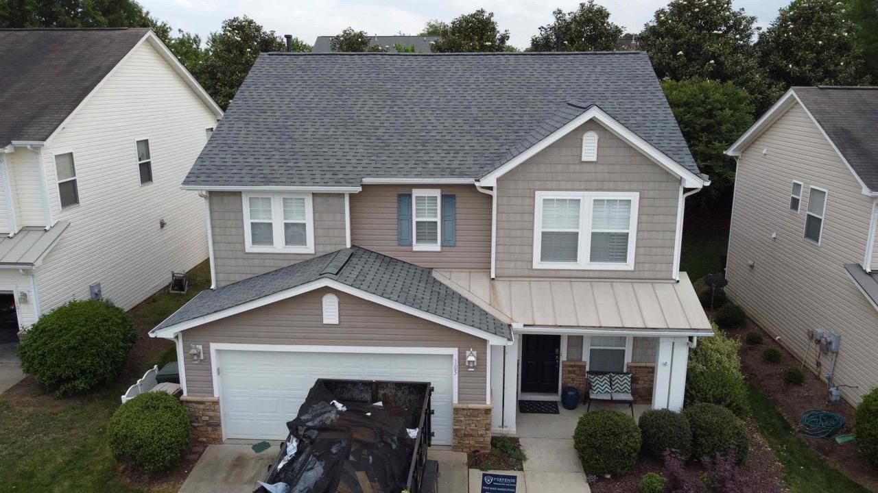 An aerial view of a clean house with a truck parked in front of it.