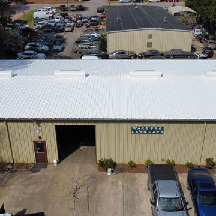 An aerial view of a large building with a white roof