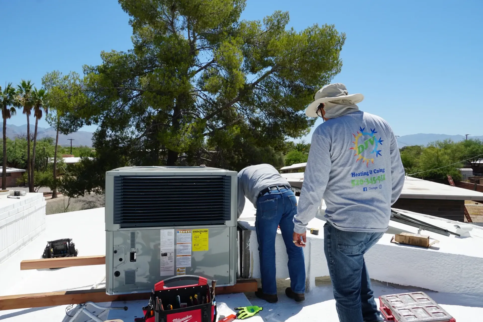 A large air conditioner is sitting on top of a concrete platform in front of a building.