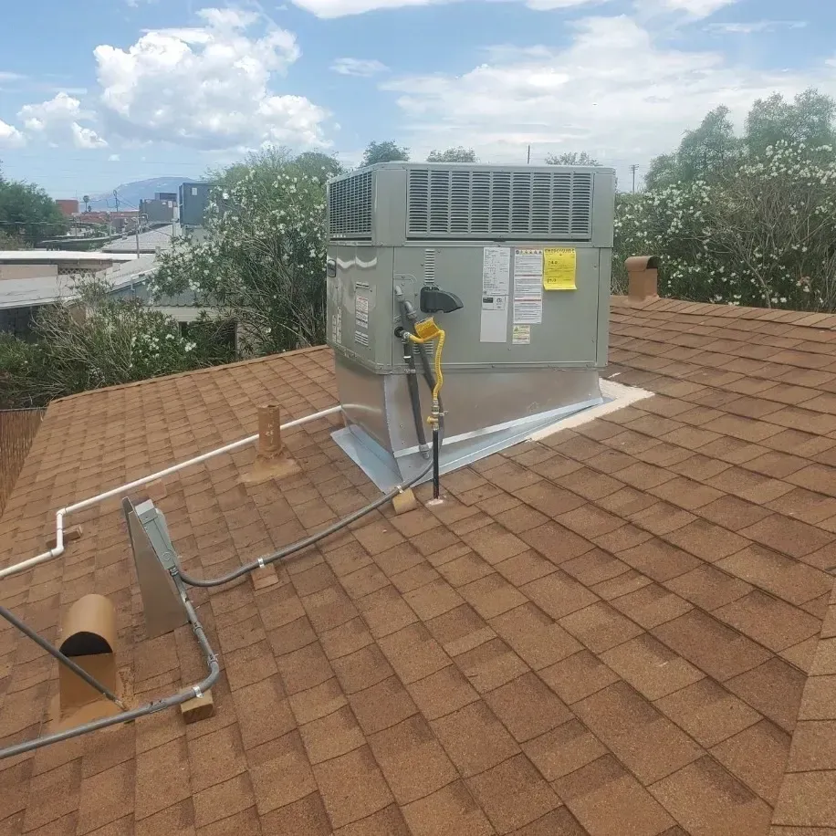 An air conditioner is sitting on top of a roof