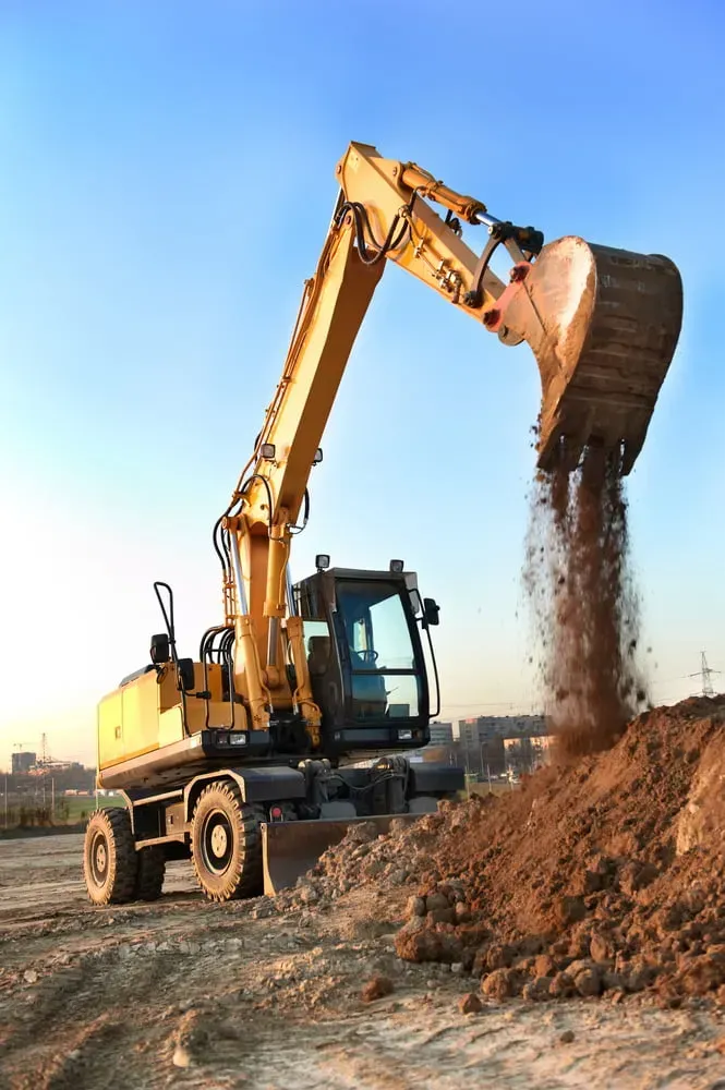 A Yellow Excavator Dumping a Scoop of Dirt — Copp & Co Civil Plant Hire in Mount Julian, QLD