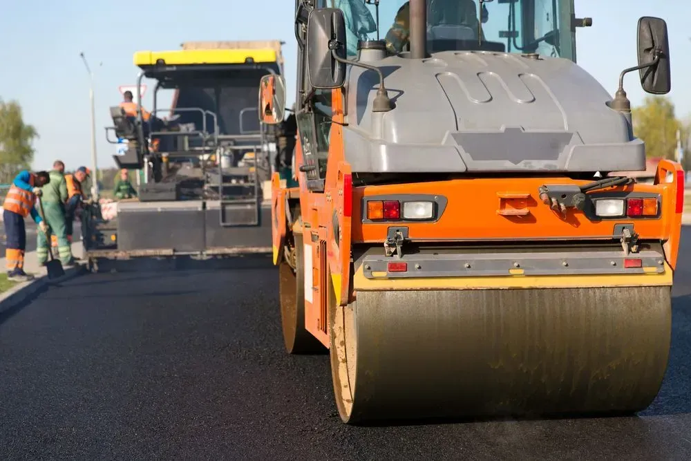 An Orange Road Roller and a Yellow Asphalt — Copp & Co Civil Plant Hire in Cannonvale, QLD