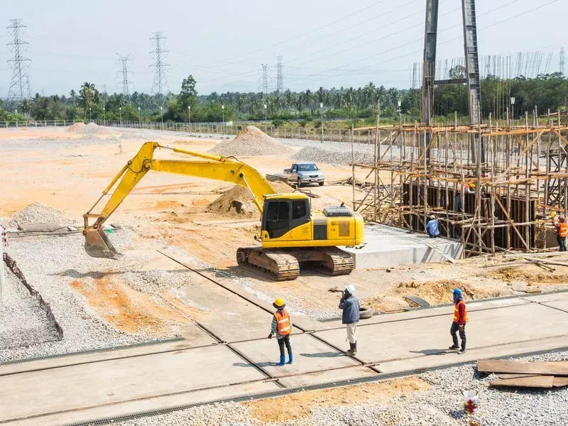 A Yellow Excavator Works on a Construction Site — Copp & Co Civil Plant Hire in Cannonvale, QLD