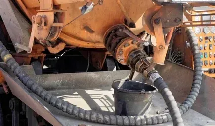 An Orange Industrial Tank With a Hose and Metal Valve — Copp & Co Civil Plant Hire in Proserpine, QLD
