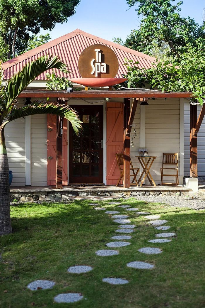 A small, light-colored building with a sign that says