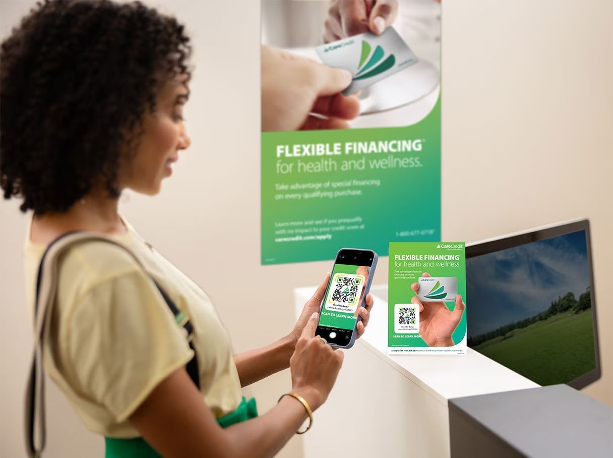 Woman scanning QR code for financing for health and wellness.