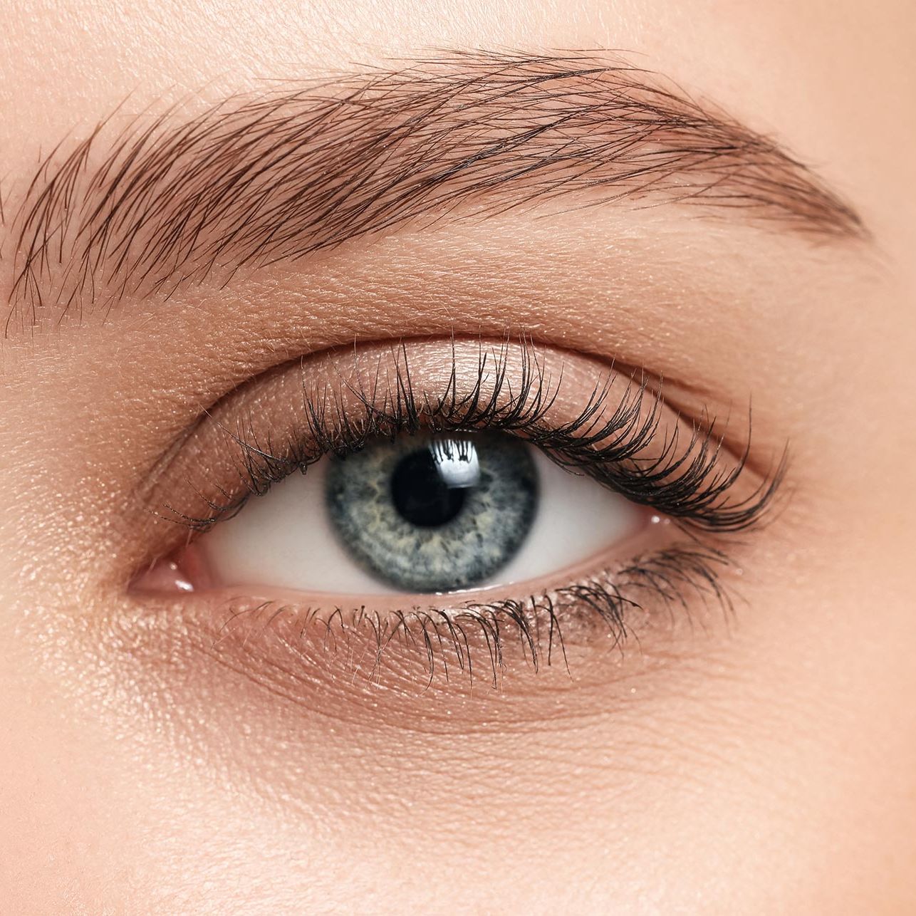 A close up of a woman 's blue eye with makeup.