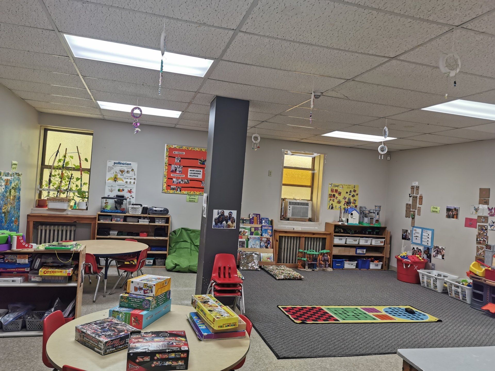 carpeted daycare centre with round tables and boock shelves