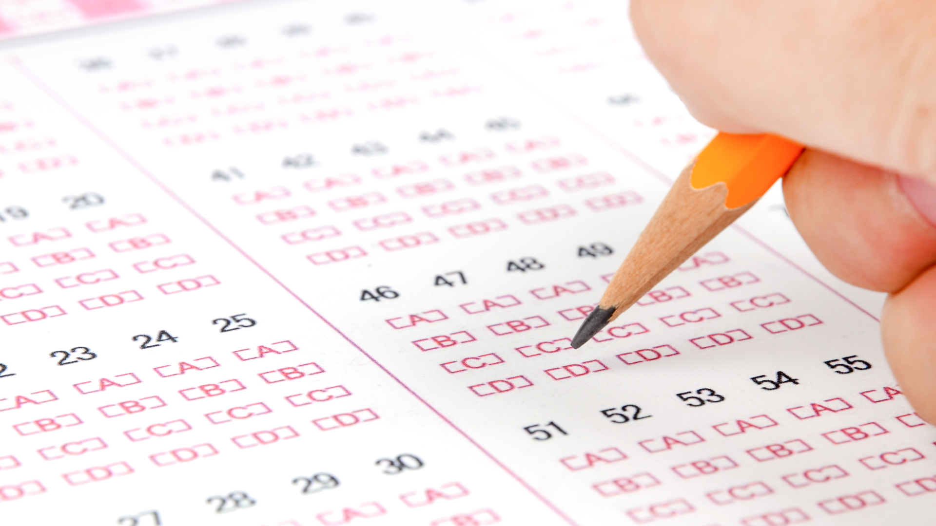 A person is taking a test with a pencil