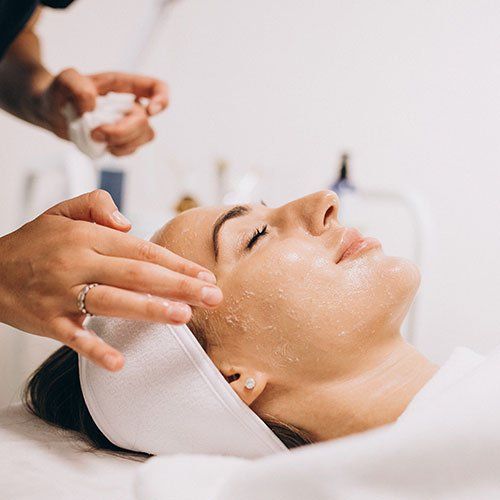 A woman is getting a facial treatment at a spa.