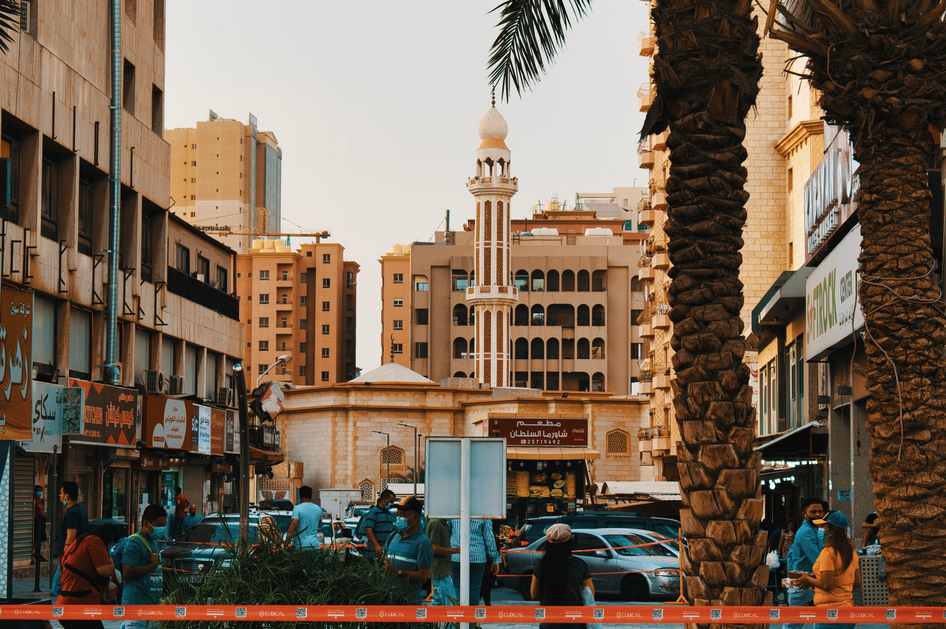 A busy city street with a mosque in the background