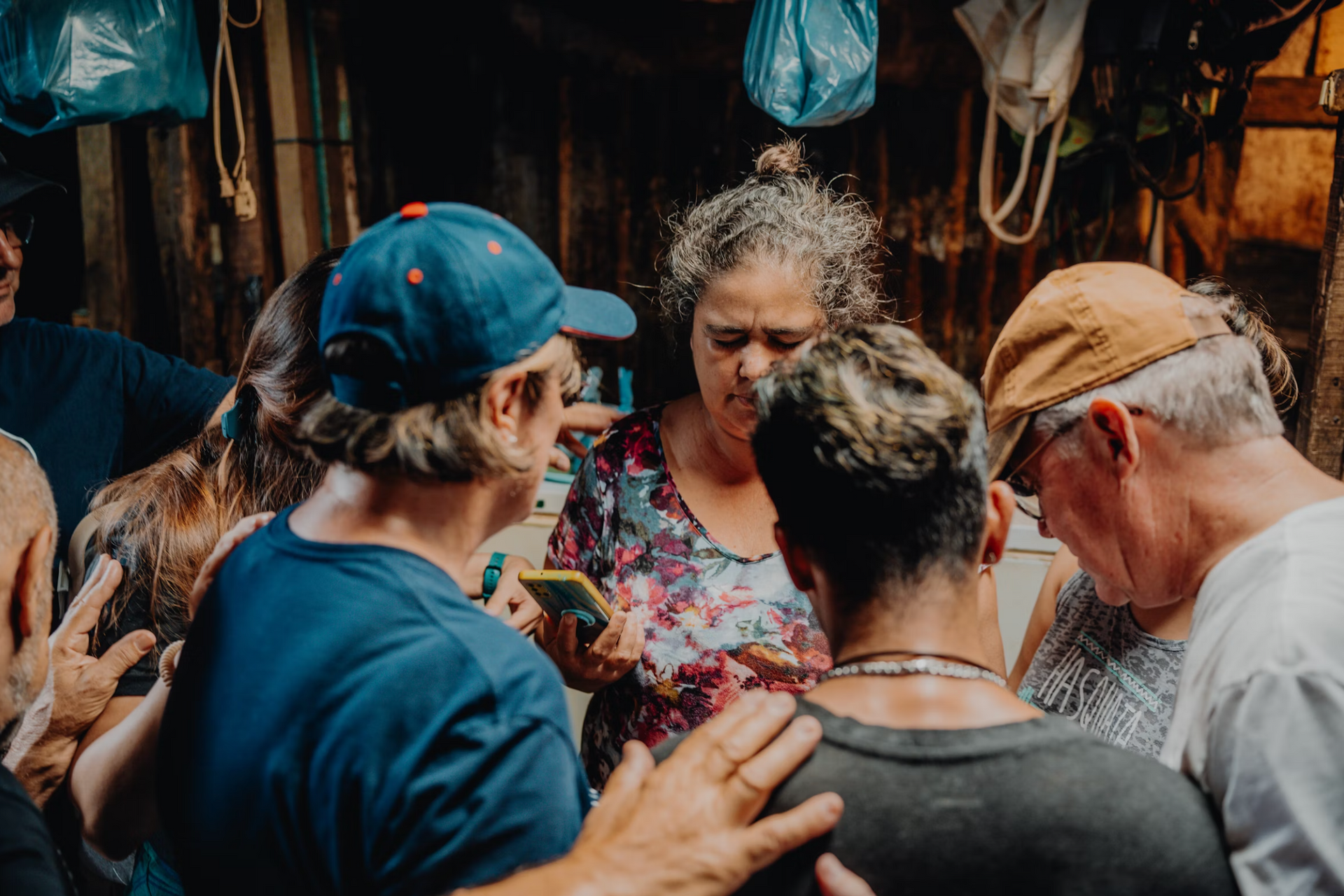 A group of people are praying for a woman.