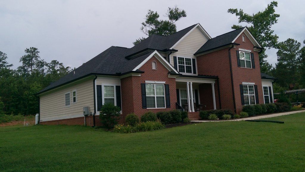 Appling home with black gutters view 4