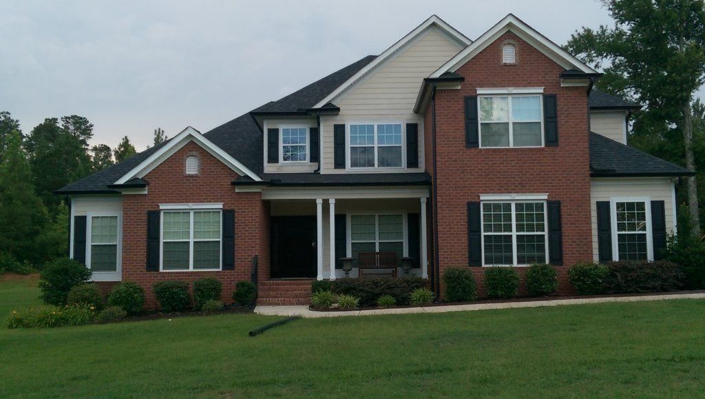 Appling home with black gutters view