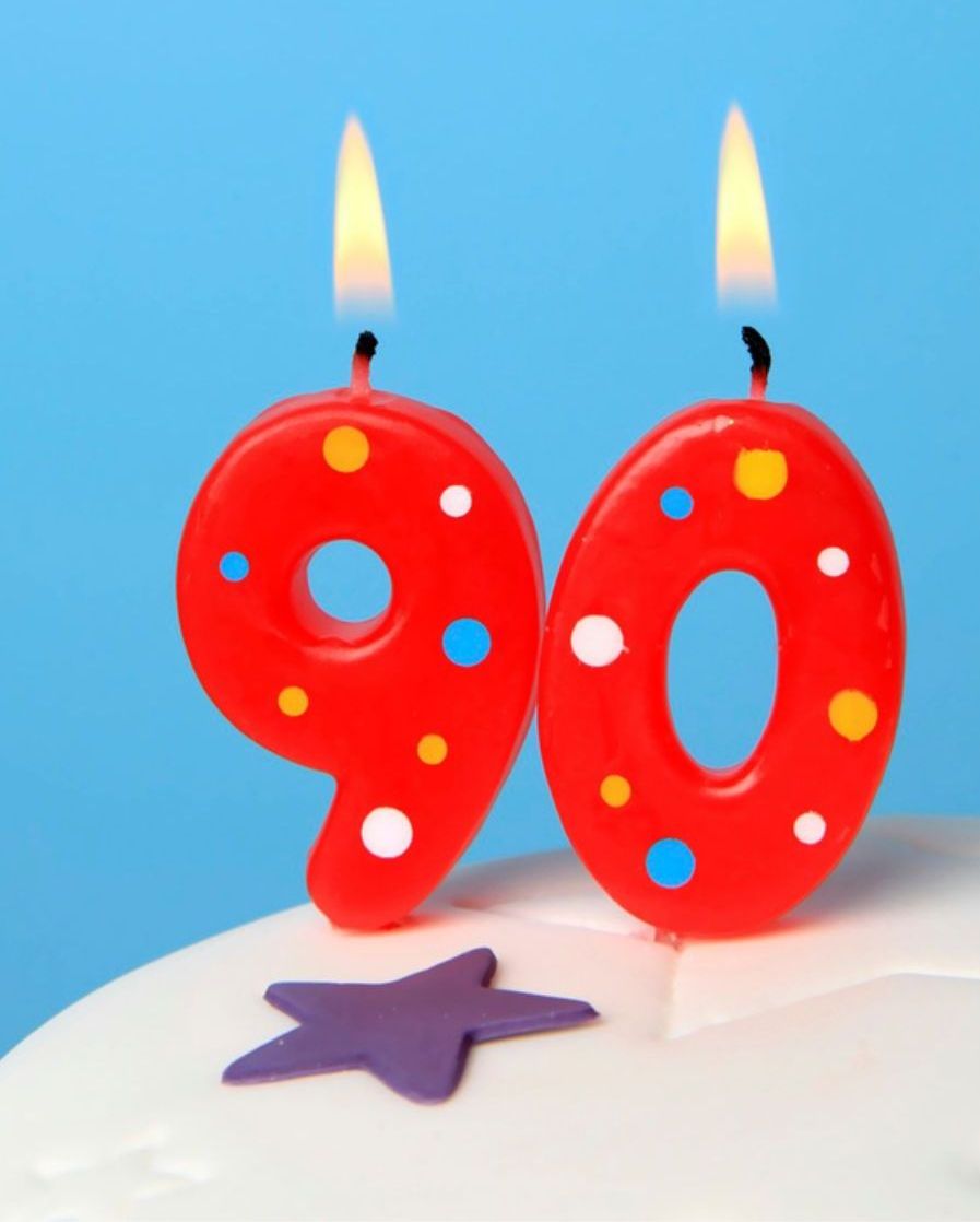 two red candles in the shape of the number 90