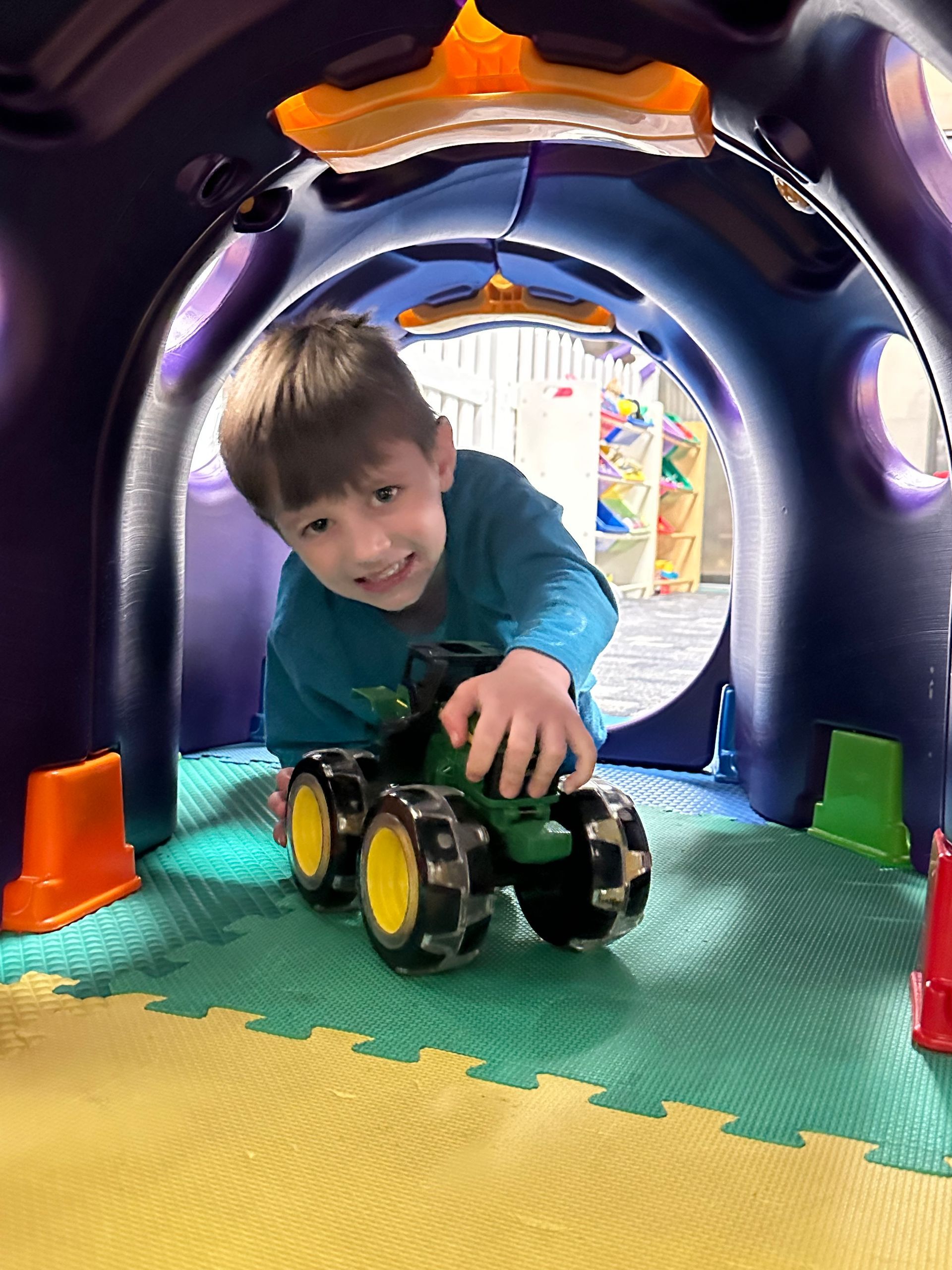 A child is playing with toys at our youth center, where we provide expert onsite childcare in Barrington.
