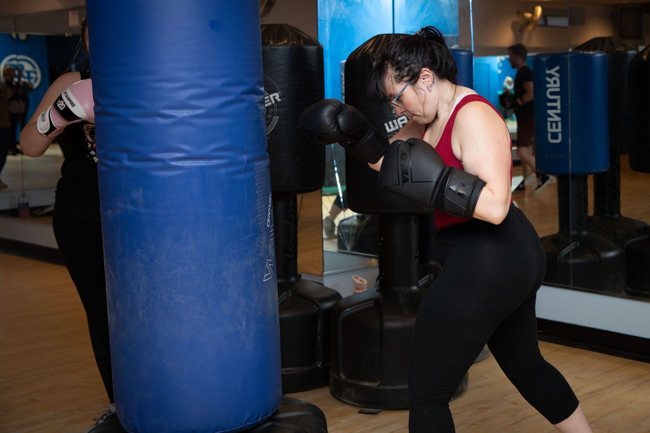 Members hitting a punching bag during our kickboxing class in Barrington.