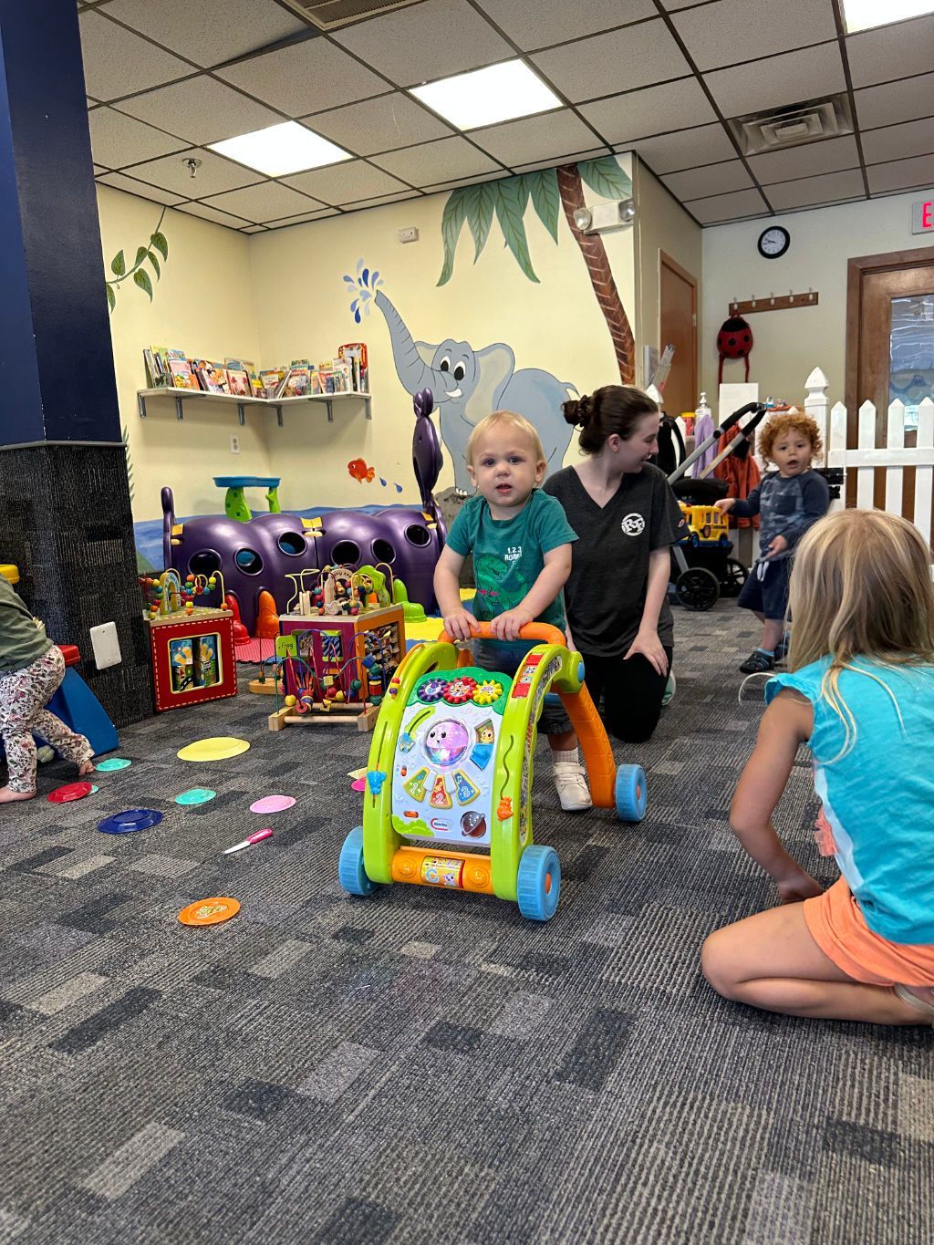 A group of children are playing with toys in a room.