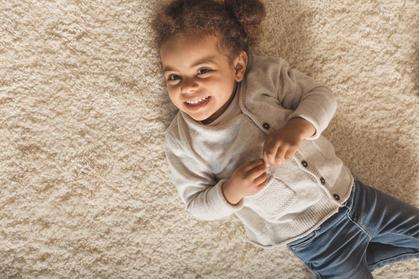 Carpet Deep Cleaning — Girl Lying Down In A Carpet in Fishers, IN