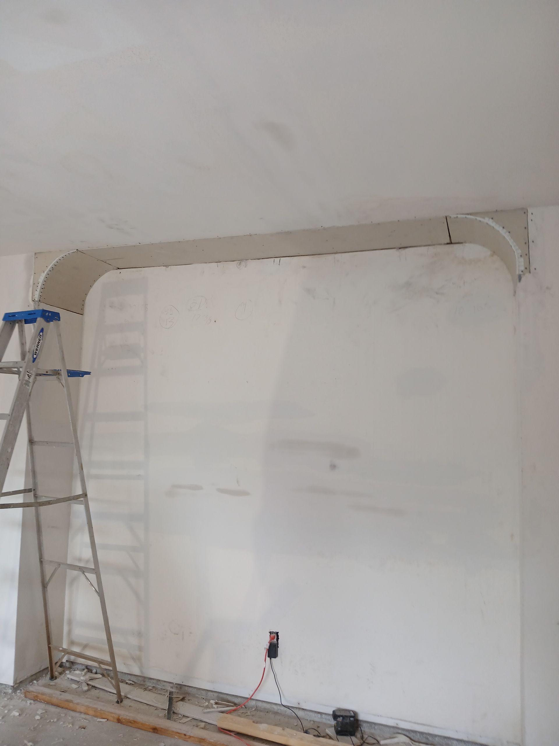 A close up of a white wall with a hole in it.