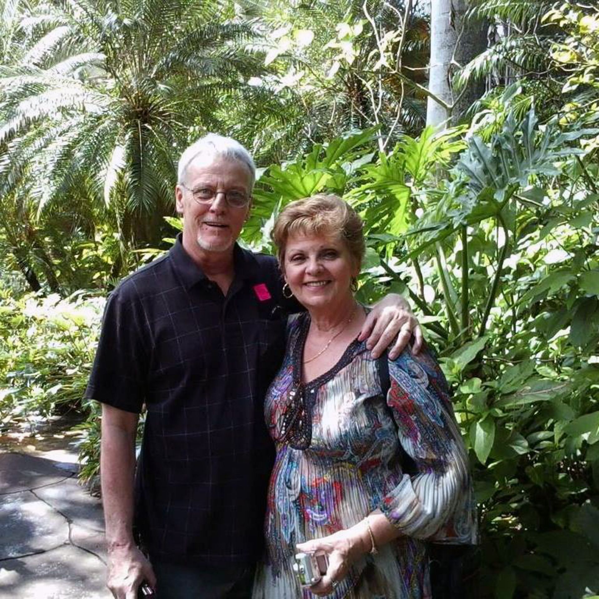 Image of Jim and Annie in front of trees and other plants