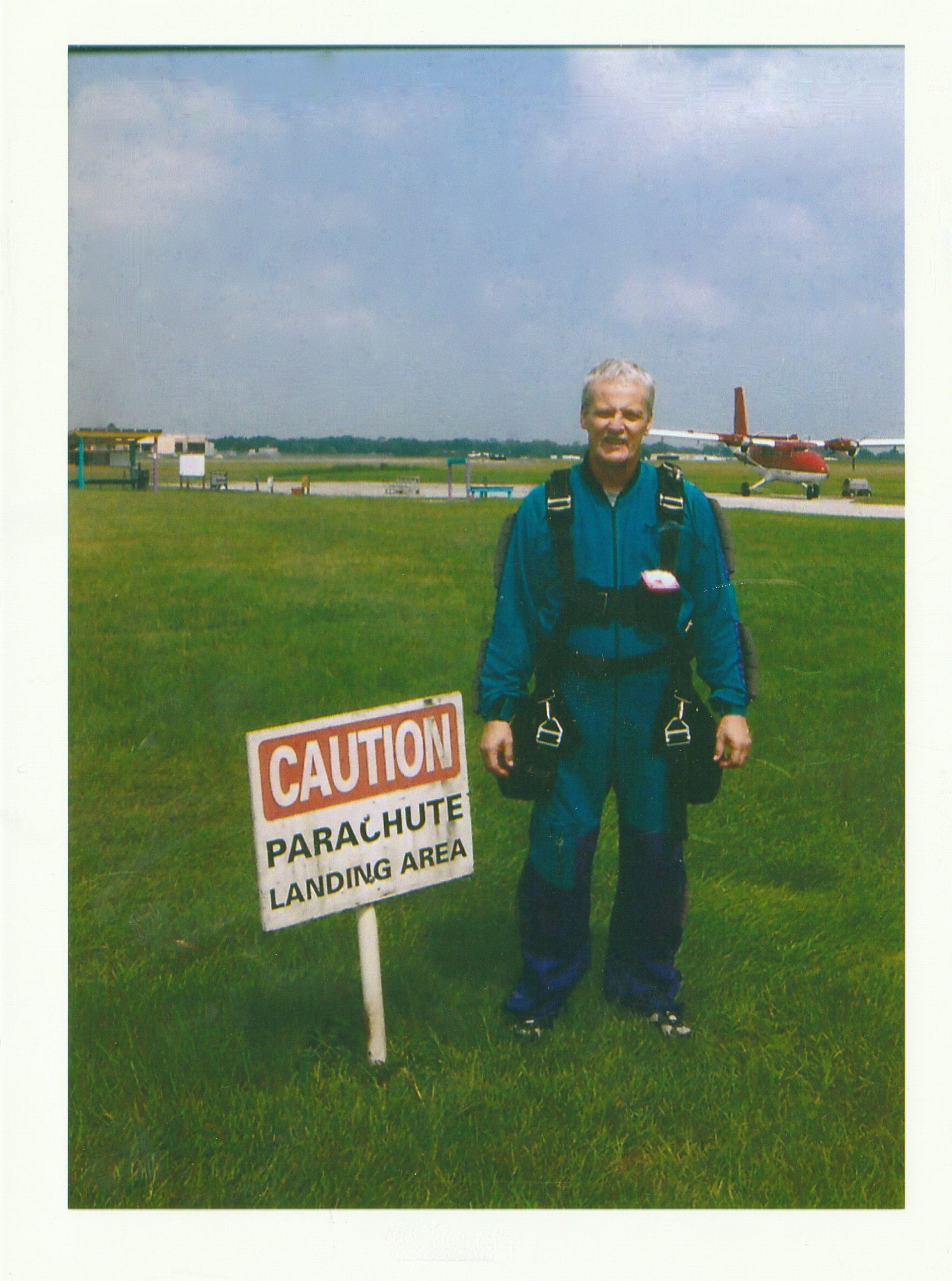 Image of Jim in parachute on a field