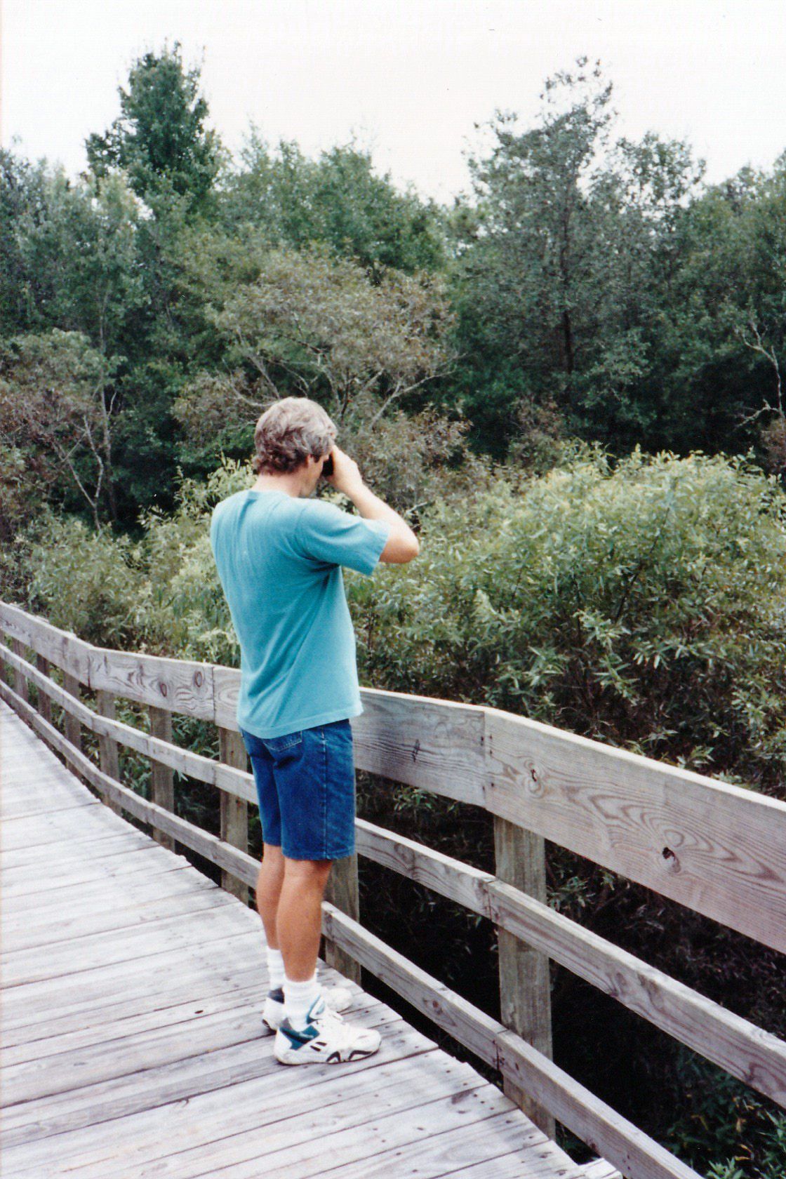 Image of Jim on boardwalk with binoculars