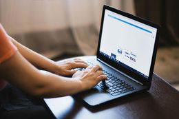 person typing on open laptop