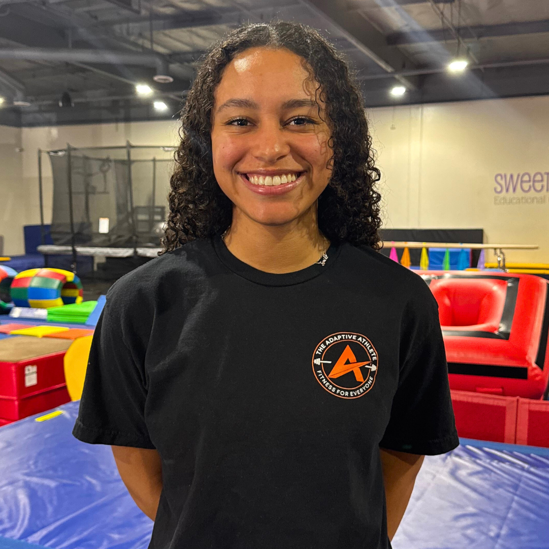 A gymnastics coach at the adaptive athlete.