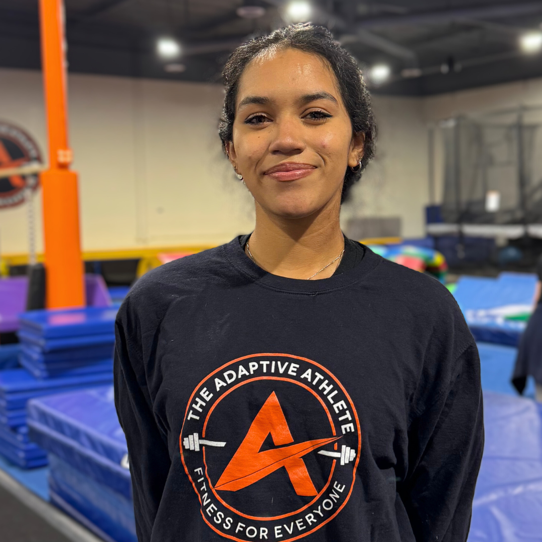 A gymnastics coach at the adaptive athlete.