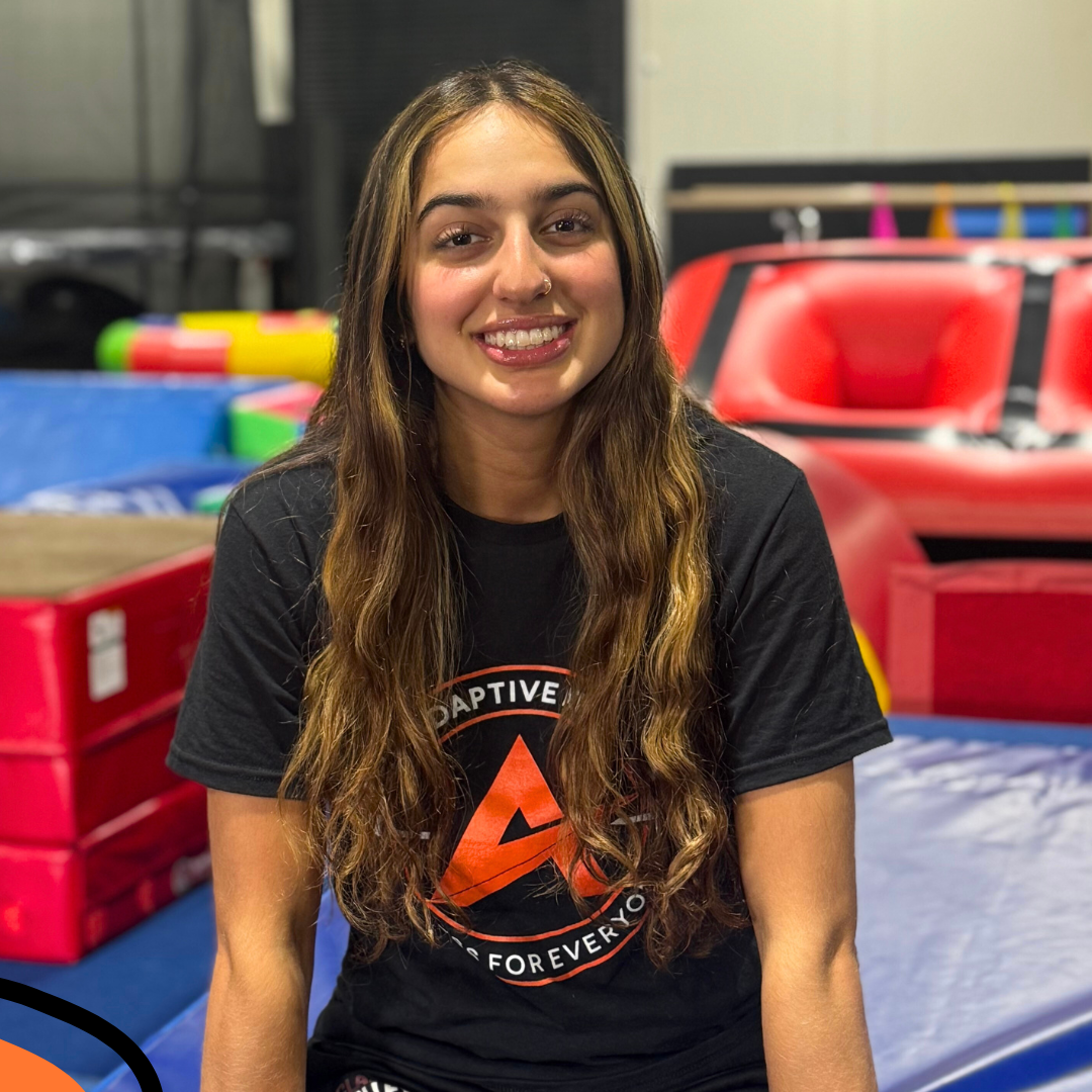 A gymnastics coach at the adaptive athlete.