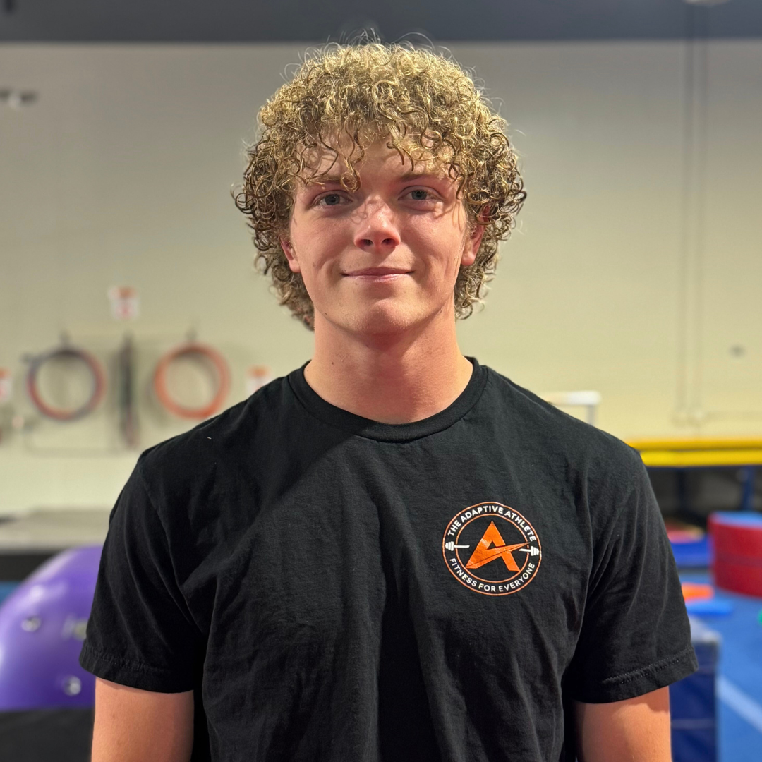A gymnastics coach at the adaptive athlete.