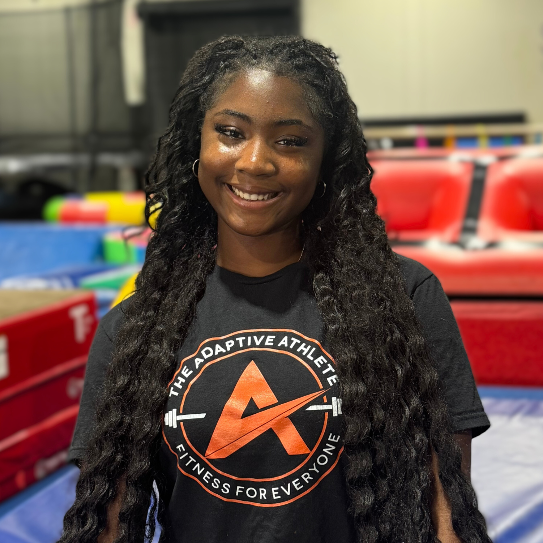 A gymnastics coach at the adaptive athlete.