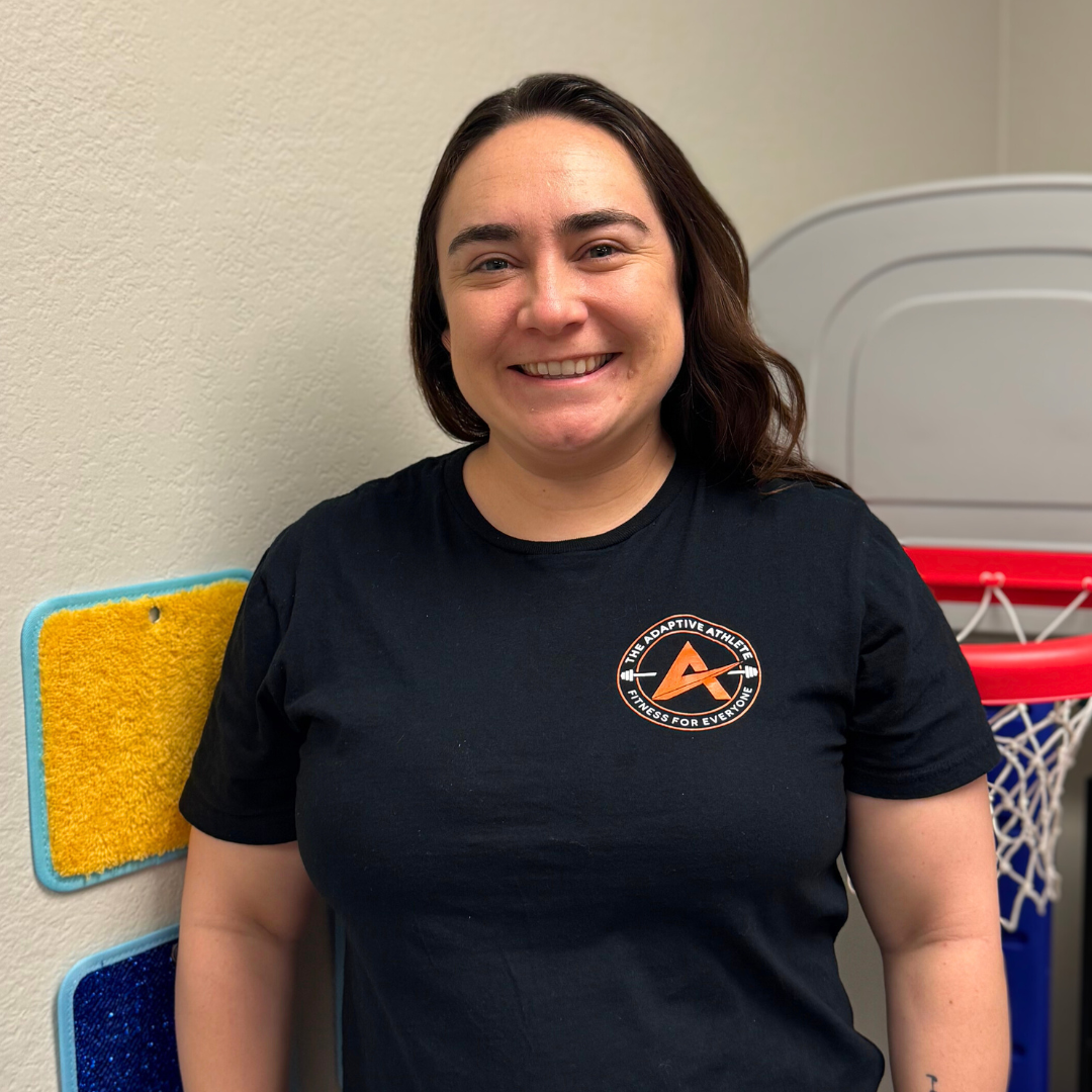 A gymnastics coach at the adaptive athlete.