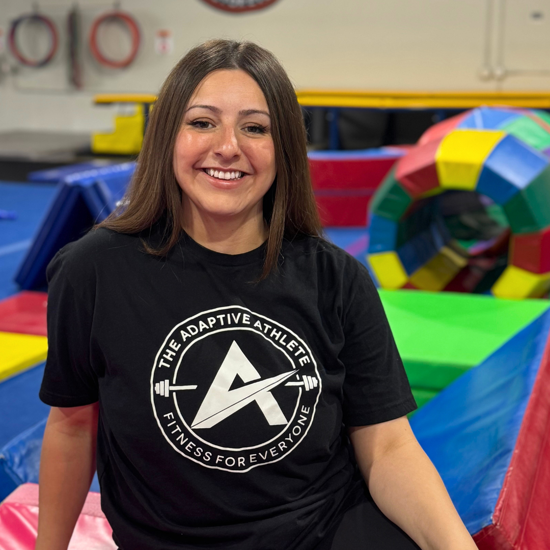 A gymnastics coach at the adaptive athlete.