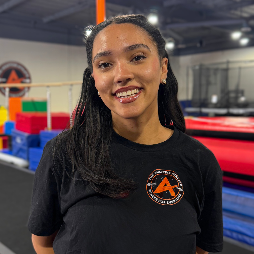 A gymnastics coach at the adaptive athlete.