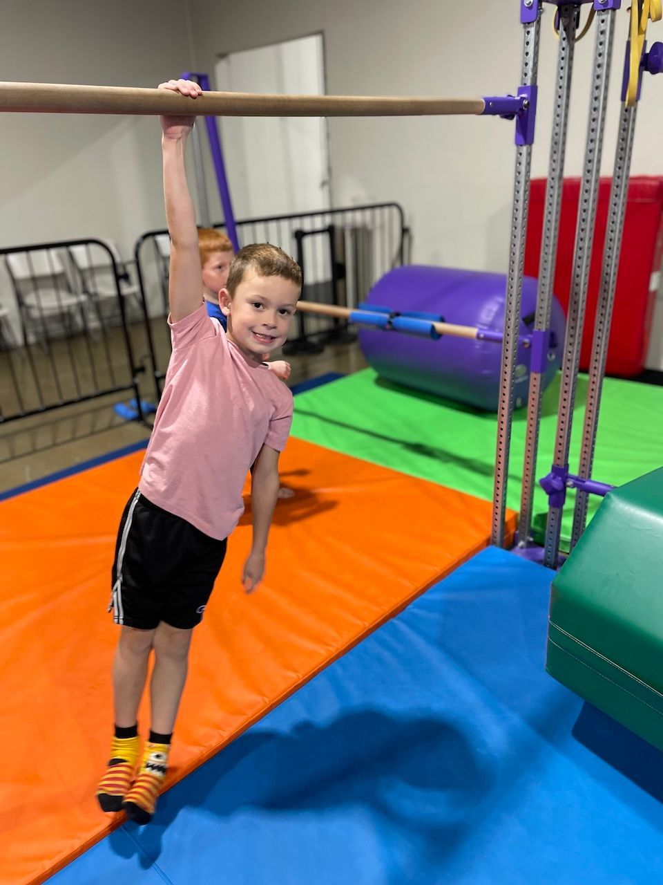 A silhouette of a person jumping in the air on an orange background.