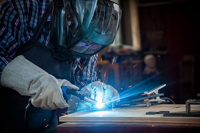Worker Welding Mechanical Parts — San Diego, CA — Sam's Welding, Inc.