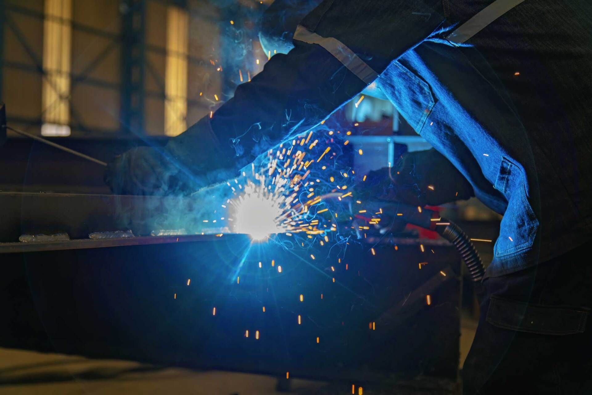 Industrial Worker Man Welding in a Factory — San Diego, CA — Sam's Welding Inc.