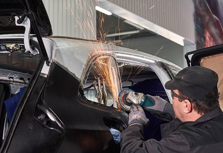  Working with Angle Grinder to Fix Damaged Car — San Diego, CA — Sam's Welding Incorporated