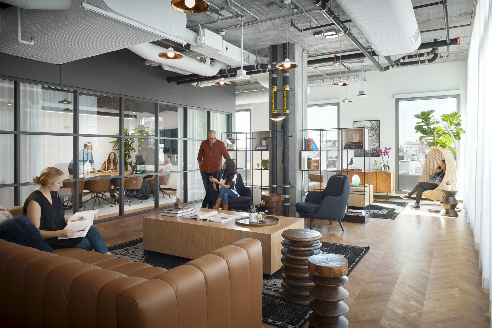 A group of people are sitting on a couch in a living room.